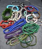 A selection of semi precious rough cut and polished stone necklaces and bracelets including a Thomas