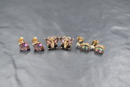 Three pairs of 9ct gold and yellow metal stud earrings, set with diamond chips, amethysts and