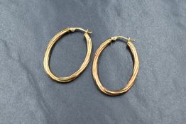 A pair of 9ct gold hoop earrings, of oval form having a twist design, marked 9kt, 1.9g