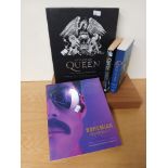 A selection of Queen books and some drumsticks - a nice set of collectables