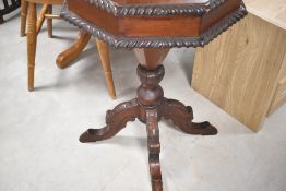 A reproduction hardwood sewing table having octagonal top, approx. diameter 50cm