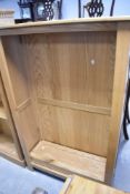 A modern golden oak bookshelf, dimensions approx. height 141 width 90 depth 32cm