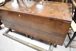 A 19th Century oak twin gateleg dining table having long flaps, width approx. 146cm, opening to a