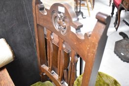 A pair of Victorian mahogany dining chairs having slat backs and overstuffed seats