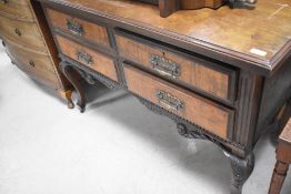 A late 19th Century mahogany bedroom chest of four short drawers, on shaped leg, possibly previously