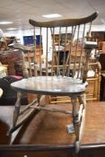 A vintage stained frame stick back rocking chair, possibly Ercol