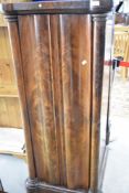 A 19th Century mahogany tall cabinet section , having heavy door with pillar supports, adapted