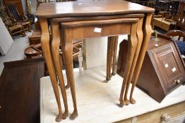 A vintage part walnut nest of three tables, having shaped legs max width approx. 49cm