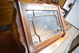 A reproduction mahogany corner wall display cabinet