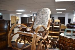 A vintage bentwood rocking chair having foliate upholstery