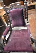 A Victorian mahogany easy arm chair having upholstered seat , back and arms