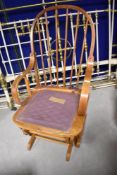 A vintage spindle back rocking chair having back and forth mechanism