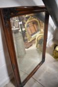 A modern mahogany effect wall mirror , approx 74 x 106cm