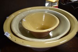 Three traditional salt glazed cream/mixing bowls, diameters 47, 40, 26.5cm