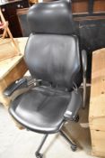 Two modern office/gaming chairs, one being fixed frame, the over on swivel and wheels with extra