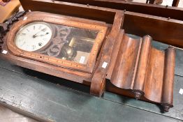 A 19th Century wall clock having animalistic carved plinth, arch glazed door, containing painted