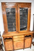 A composite bookcase comprising early 20th Century top with Art Deco influences over a late