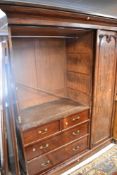 A 19th Century mahogany triple wardrobe/linen press having hinge and veneer damage, height approx.