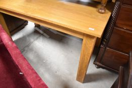 A modern golden oak dining table, approx 153 x 92cm