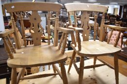 A set of six (four plus two) solid seated fiddle back kitchen chairs