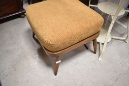 An Ercol foot stool , in mid stain, with cushion, approx. 55 x 55cm