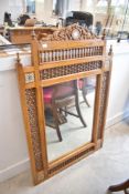 An Anglo Indian style wall mirror having bobbin turned surround and inlaid decoration, approx. 113 x