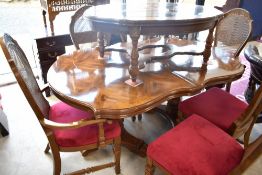 A vintage Continental style extending dining table and set of six (four plus two dining chairs),