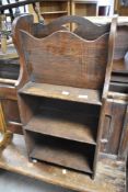 An early 20th Century oak bookrack with shelves under, dimensions approx. Height 76 width 38cm