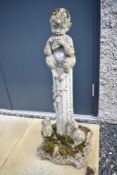 A concrete garden ornament modelled as boy on plinth (possibly Pan) with squirrels to base, height