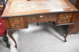 A late 19th or early 20th Century ladies writing desk having inset pen and inkholders, skiver top on