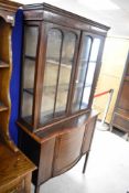 An Edwardian mahogany and line inlay display cabinet having glazed section over lower bowed