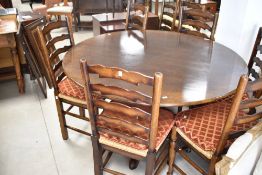 A nice quality reproduction oak pedestal dining table having circular top, turned column and