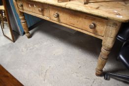 A traditional stripped pine kitchen table , probably 19th Century, with two deep drawers and