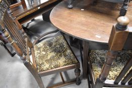 An early to mid 20th Century oak gateleg table and a part set (four plus one) of similar chairs (one