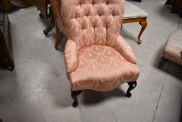 A modern nursing chair having classical rose pink upholstery
