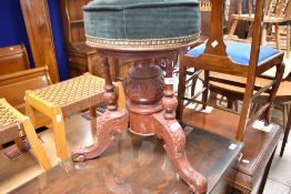 A reproduction piano stool in the Victorian style, overstained