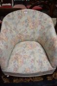An early to mid 20th Century tub armchair having floral upholstery and cabriole legs