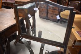 An early 20th Century oak toilet mirror (missing one acorn finial) width approx. 56cm