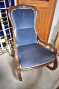 A Victorian mahogany part upholstered low rocking chair with incised detail and padded back and