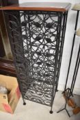 A modern metal wine rack (23 bottle) witrh vine decoration and wood top, height approx. 112cm