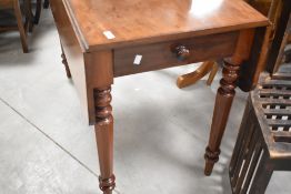 A Victorian mahogany dining table having frieze drawer and drop flaps having frieze drawer and