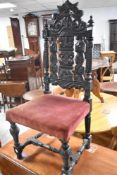 A 19th century carved oak dining chair in the Charles II style with arched, pierced and carve