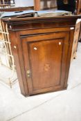 A 19th Century oak corner wall cupboard having inlaid decoration, height approx. 103cm