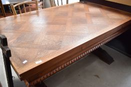 A mid 20th Century golden oak drawer leaf table having parquet style top on carved bulbous double