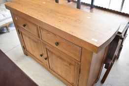 A modern golden oak sideboard having two frieze drawers and double cupboard, dimensions approx,