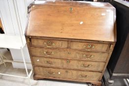 A Georgian mahogany bureau having fitted interior under fall flap , and two over three drawer