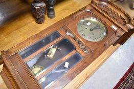 An early 20th Century wall clock having brassed dial with Arabic numerals , height approx. 85cm