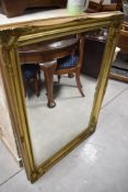A modern gilt framed wall mirror, approx. 107 x 76cm