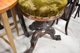 A Victorian mahogany swivel seat piano stool