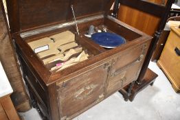 A late 19th or early 20th Century oak cased gramophone , with quantity of 78s